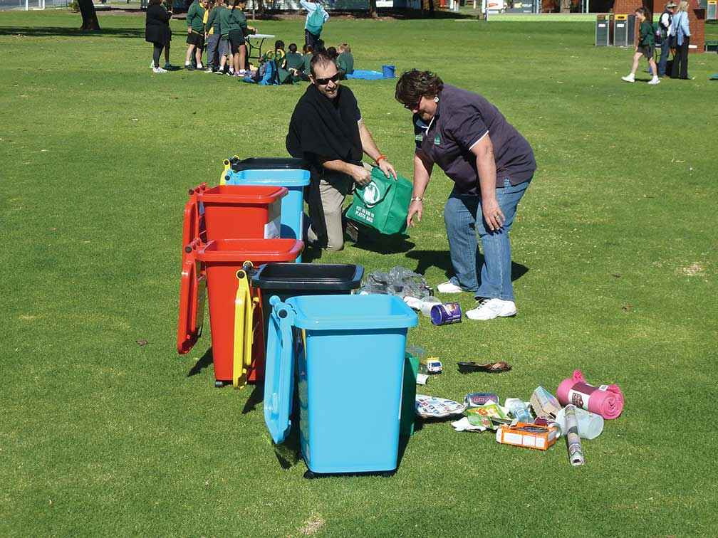Lanie Pearce demonstrates a recycling relay race at an environmental games day attended by 200 local students at Victoria Park Lake in Shepparton.