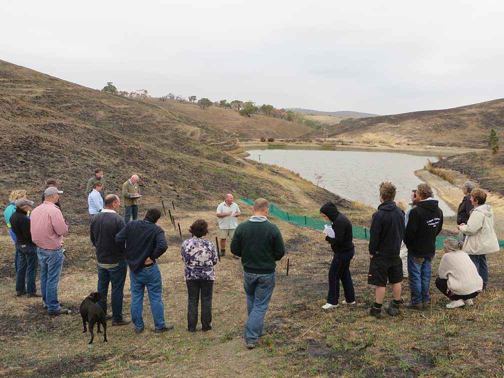 Greg Bekker from Agriculture Victoria demonstrates the use of sediment barriers for siltation and erosion control at Karen and Peter Ivory’s property at Darraweit Guim in March 2014.