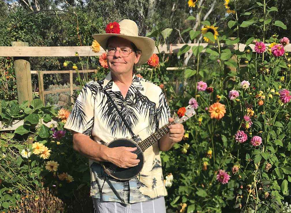 Richard MacEwan enjoys a musical interlude in his labour intensive but highly productive garden.