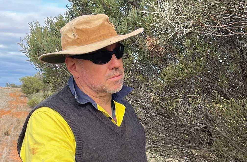 Ian Arney checking seedpods on his property Mallanbool at Millewa.