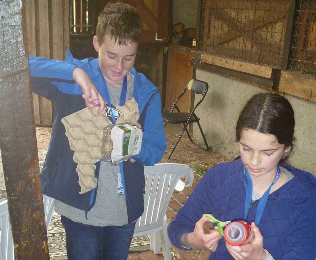 Alex Turner and Jasmine Thomas making puppets from recycled trash.