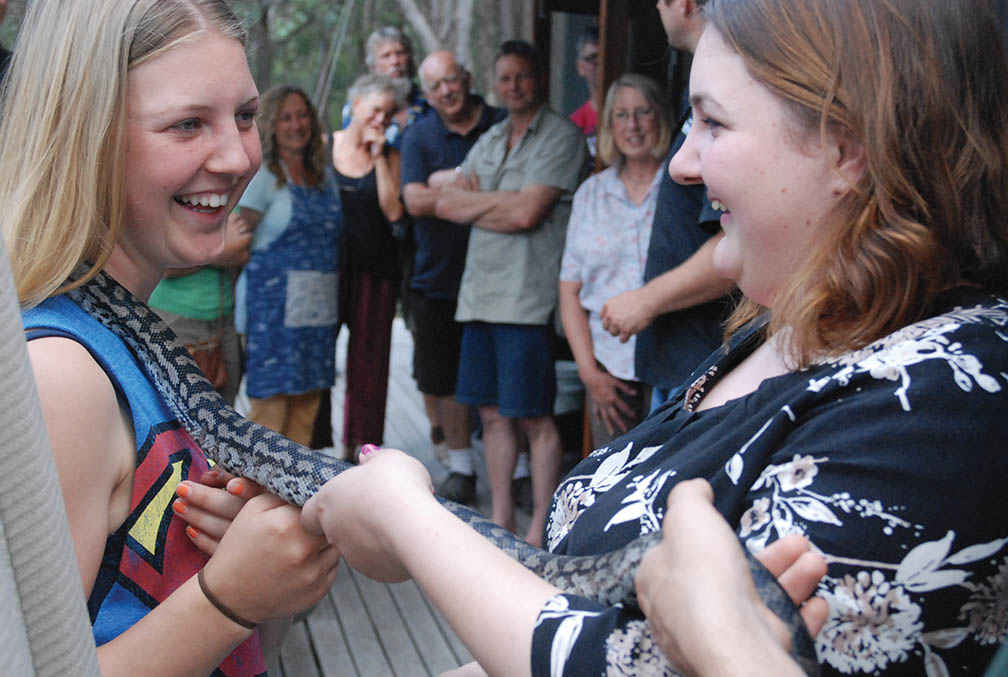 Sisters Tayla and Jordan Keene bond with a carpet snake.